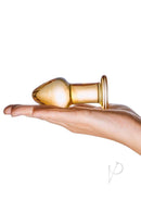 Glas Over Easy Glass Butt Plug Orange displayed on a hand, showcasing its premium glass design and glossy finish.