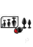Luxe Bling Silicone Anal Training Kit Red Gems Black with three progressively sized plugs and sparkling red gem bases.