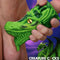 Creature Cocks Dragon Tamer Silicone Stroker Green featuring a dragon head design held in hand.