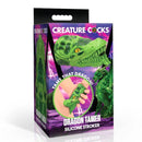 Creature Cocks Dragon Tamer Silicone Stroker Green packaging with dragon head design and hand holding stroker.