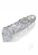 Oxballs Butch Cock Sheath Penis Extender Clear on a reflective surface with a textured design.