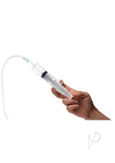 Clear syringe held in hand with measurement markings and tubing attached for fluid application.