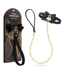 Temptasia Ardor Collar and Leash with Bow Black displayed with packaging and gold chain, highlighting elegant design.