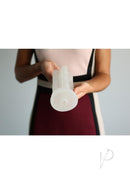 Kiiroo Titan Power Stroker Sleeve Clear held in hand, showcasing its design and texture for enhanced performance.