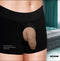 Strap U Uncut Packer Silicone 5.1 inches Dildo Caramel displayed in black boxer shorts.