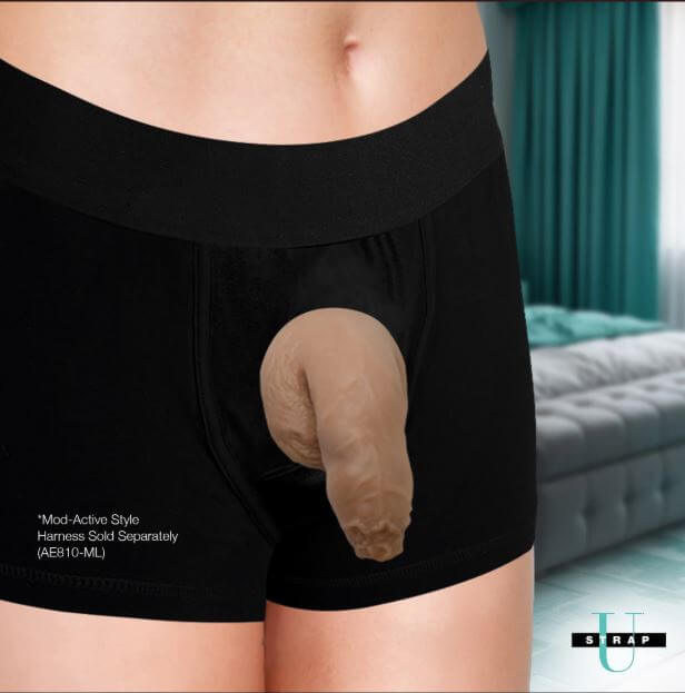 Strap U Uncut Packer Silicone 5.1 inches Dildo Caramel displayed in black boxer shorts.