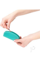 Hand holding PowerBullet Silicone Storage Bag with Zipper Teal while unzipping the pouch.