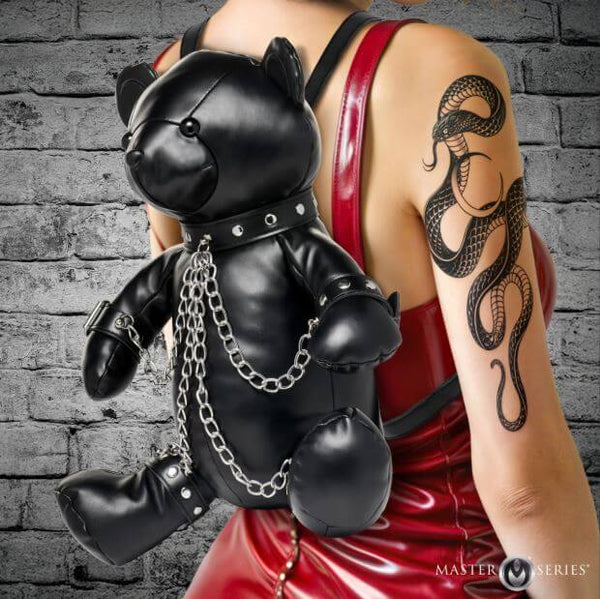 Master Series BDSM Bear Backpack Black worn on a model featuring a bear in bondage gear with chains and soft black finish.