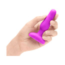 b-Vibe Novice Remote-Controlled Vibrating Anal Plug Fuchsia held in hand, showcasing its compact design.