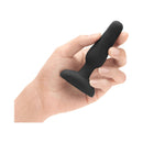 b-Vibe Novice Remote-Controlled Vibrating Anal Plug Black held in hand showing its compact design.