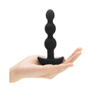 b-Vibe Triplet Remote Controlled Anal Beads Plug Black held in hand showcasing its flexible design and tapered shape.