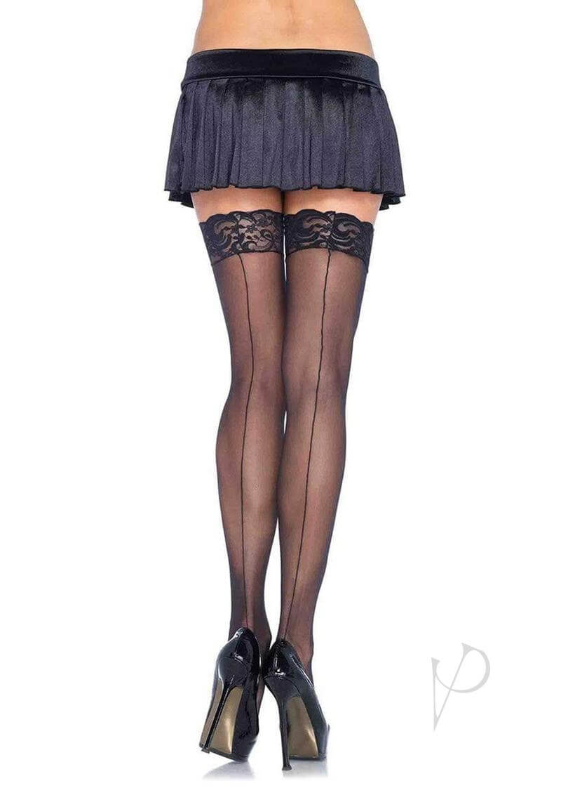 Leg Avenue sheer black stockings with lace top and backseam, worn with a pleated black skirt and high heels.