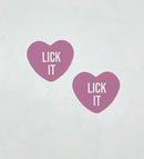 Lick It Light Pink Candy Heart Pasties featuring playful heart shapes and bold lettering for a fun look.