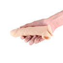 Renegade Annex Thin Silicone Penis Extension Flesh held in a hand, showcasing its realistic design and texture.