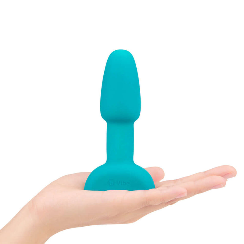 b-Vibe Rimming Petite Rotating and Vibrating Remote Control Plug Teal held in a hand showing its compact size.