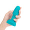 b-Vibe Rimming Petite Rotating and Vibrating Remote Control Plug Teal held in hand, showcasing its smooth design.