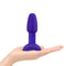 b-Vibe Rimming Petite Rotating Remote Control Plug Purple in a person's hand showcasing its design and size.