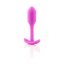 b-Vibe Snug Plug 1 Weighted Silicone Anal Plug Fuchsia on a reflective surface