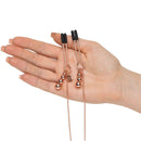 Fifty Shades Freed All Sensation Nipple & Clitoral Chain held in hand, showcasing elegant design and adjustable elements.