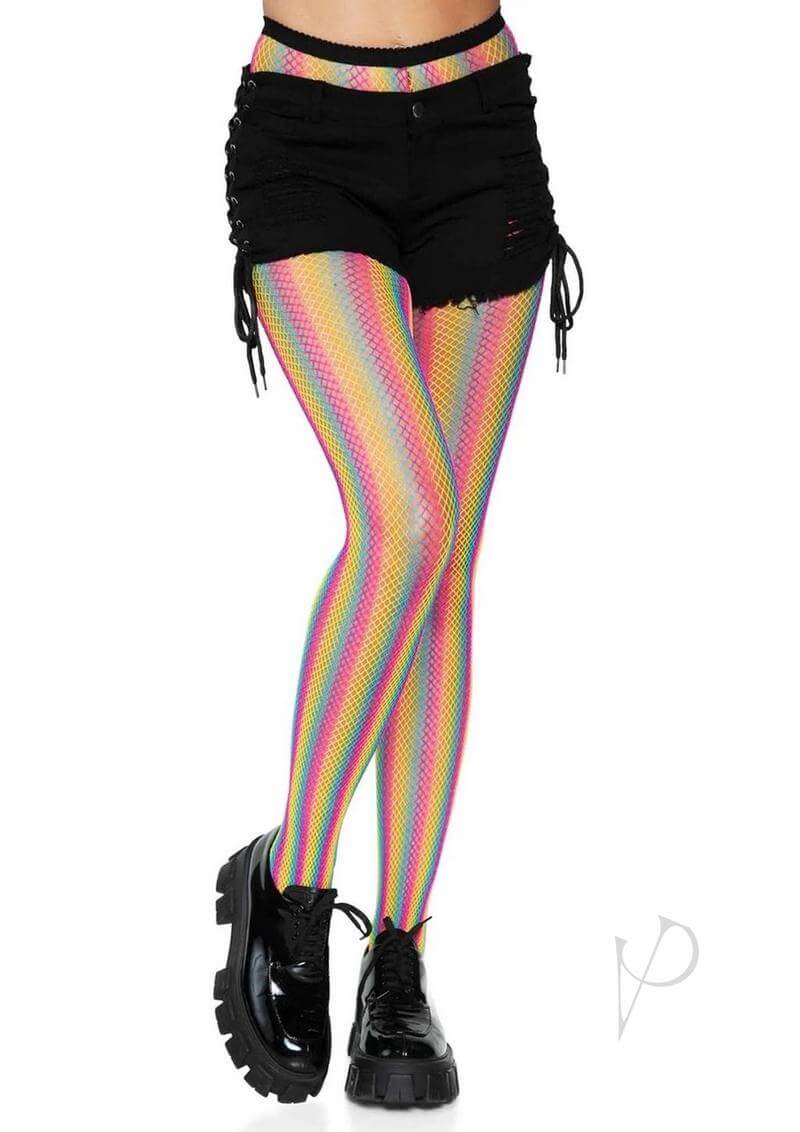 Neon rainbow striped fishnet pantyhose paired with black shorts and chunky shoes, showcasing a vibrant summer look.