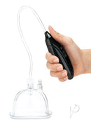 Lux Fetish Rechargeable Pussy Pump with Clit Clamp Black in hand, demonstrating suction feature.