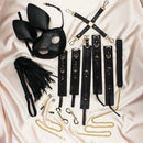 Edonista Alice 14 Piece Bondage Set including a black rabbit mask, restraints, and sensation tools on satin fabric.