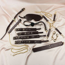 Edonista Venice 14 Piece Bondage Set with various restraints and accessories arranged on a soft fabric surface.
