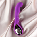 Edonista Colt G-spot Vibrator Purple on satin fabric, showcasing its ribbed design and curved tip.