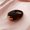 Edonista Luca Vibrating Penis Ring Black resting on soft fabric, designed for enhanced pleasure with multiple vibration modes.