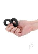 Renegade Erectus Silicone Cock Ring Black held in hand showcasing its flexible design and sleek finish.