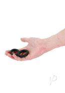 Renegade Twofold Silicone Cock Ring Black held in a hand, showcasing its sleek design and soft texture.