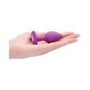 Ouch Silicone Diamond Heart Butt Plug Purple Regular in hand showcasing its design and sparkling diamond accent.