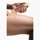 Sense Water Based Lubricant 145 ml bottle held above a thigh with lubricant applied.
