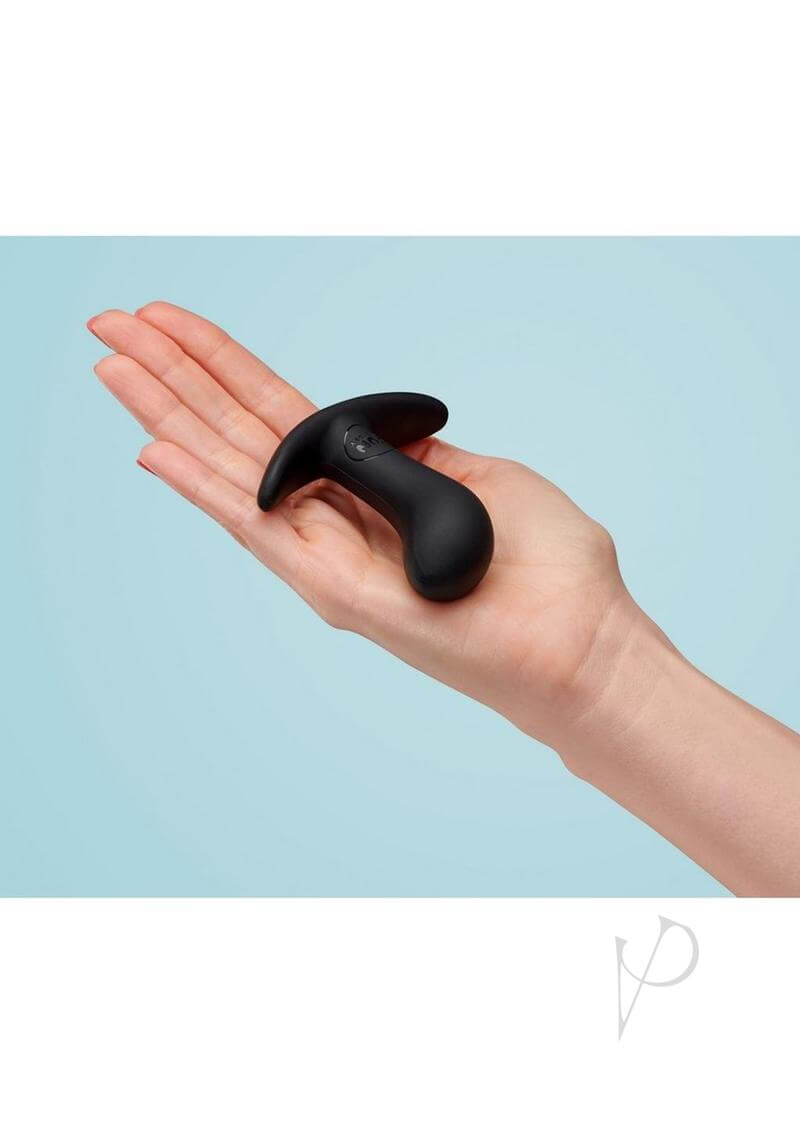 Black FUN FACTORY Bootie Small butt plug held in hand, ideal for beginners and anal play enthusiasts, featuring a soft, flexible design.