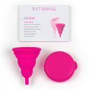 Intimina Lily Cup Compact Size B Menstrual Cup in bright pink with a user manual and compact case.