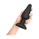 b Vibe Rimming XL Rotating and Vibrating Remote Control Plug Black held in hand, showcasing its design and features.