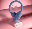 Gender X Egg-Streme Rechargeable Silicone Egg Blue resting on display holder against a pink background.