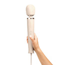 Le Wand Plug-In Vibrating Massager Cream held in hand, showcasing its sleek design and plug-in features.