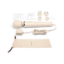Le Wand Plug-In Vibrating Massager Cream with accessories and charging power supply in cream color.