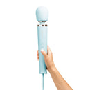Le Wand Plug-In Vibrating Massager Sky Blue held in hand, showcasing its sleek design and plug-in functionality.