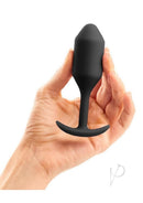 B-Vibe Snug Plug 2 Silicone Weighted Anal Plug Black in hand, showcasing its sleek design for comfort and sensual pleasure.