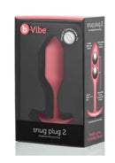 B-Vibe Snug Plug 2 Silicone Weighted Anal Plug Coral in packaging, showcasing its design and features for comfortable use.