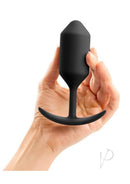 B-Vibe Snug Plug 3 Silicone Weighted Anal Plug Black held in hand against a white background.