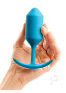 B-Vibe Snug Plug 3 Silicone Weighted Anal Plug Teal held in hand, showcasing its sleek design.