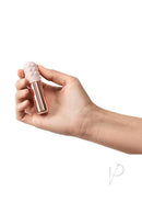 Le Wand Bullet Vibrator with Textured Sleeve Rose Gold held in hand, showcasing its compact design and luxurious finish.