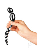 Le Wand Swerve Dual End Probe Stainless Steel held in hand for G-spot or prostate stimulation.