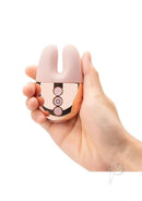 Le Wand Double Vibe Rechargeable Silicone Vibrator Rose Gold held in hand for dual stimulation.