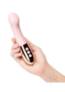 Le Wand Gee Silicone G-Spot Vibrator Rose Gold held in hand showcasing its sleek design and control buttons.