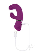Playboy Tap That Silicone G-Spot Vibrator Purple charging with USB cable against a white background.
