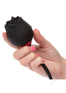 French Kiss Elite Romeo Clitoral Silicone Vibrator Black held in hand with pink nails, showcasing elegant design and usability.